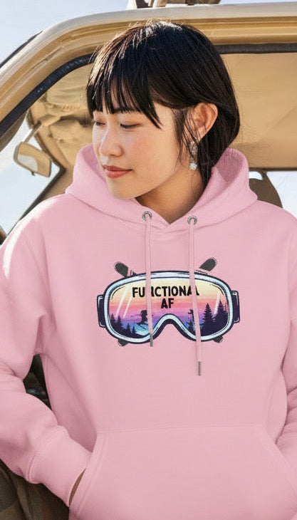 Person wearing a pink Functional AF googles hoodie, sitting inside a vehicle.